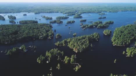 Push-in-drone-view-of-a-remote-cottage-lake