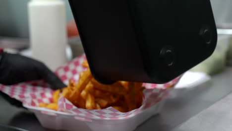 dumping french fries in to a serving basket - food truck series