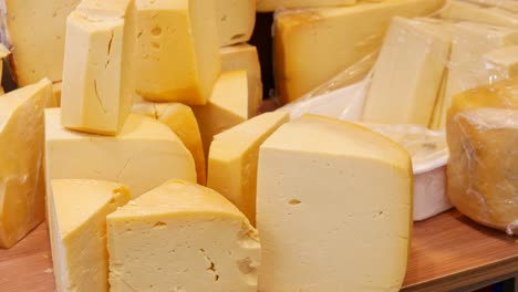 assortment of yellow cheese blocks at a market