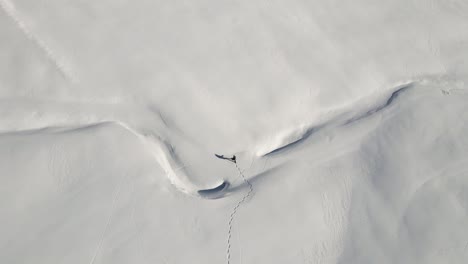 A-single-Man-is-hiking-in-the-middle-of-the-snowy-italian-mountains-with-his-snow-shoes