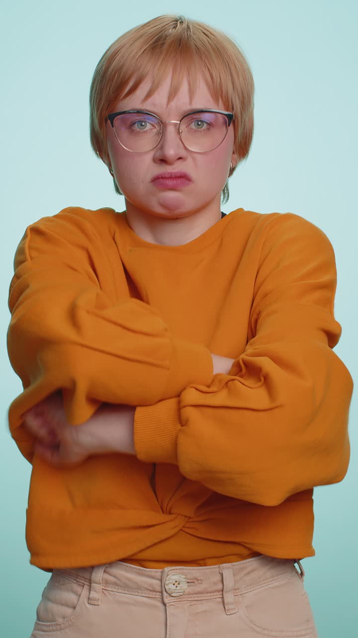 Aggressive young woman trying to fight at camera shaking fist boxing with expression punishment