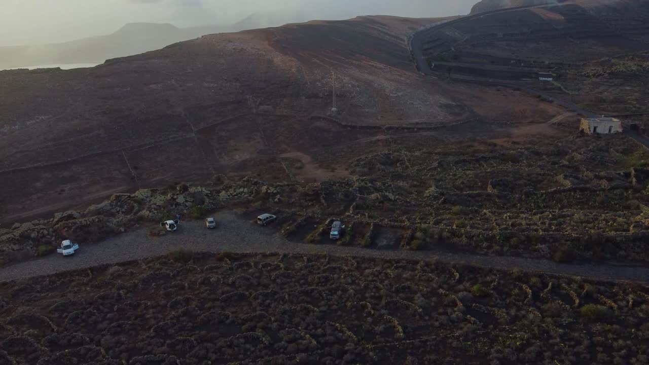 Vehicles Park At The Vineyards Of La Corona Volcano In Lanzarote, Canary Islands, Spain. aerial