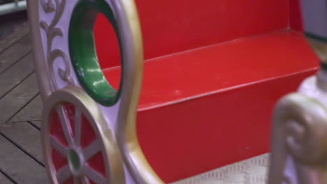 a stationary shot of part of the carousel with kids on the ride