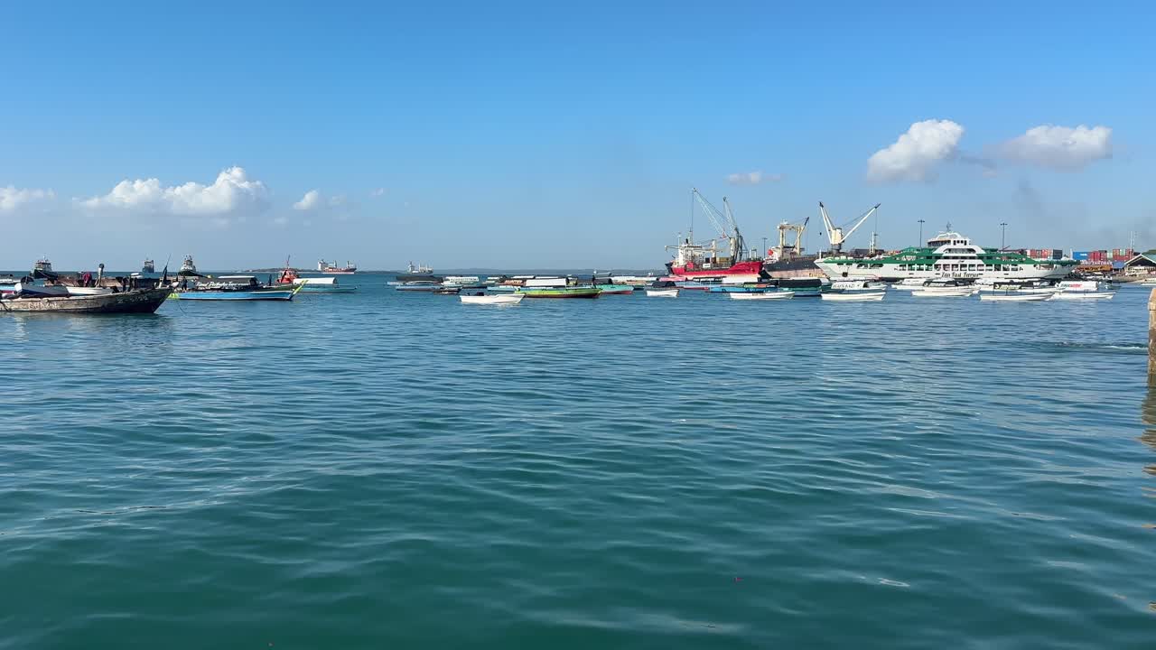 Boats ships at the harbour port in stone town zanzibar city tanzania
