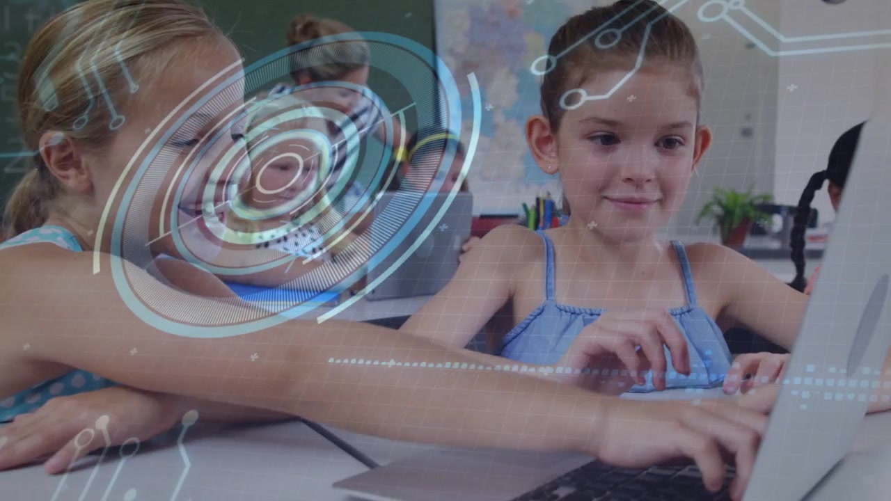 HUD overlay appearing over class working girls on laptop typing and smiling teacher helping school