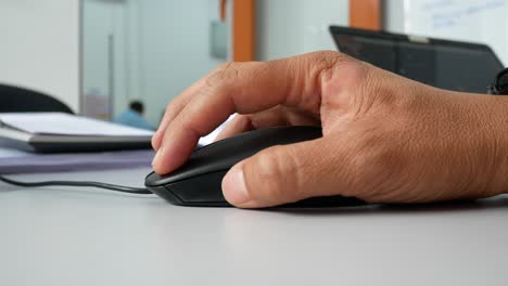 a man hand using black computer mouse