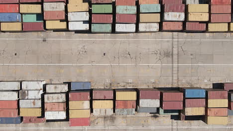 Aerial:-Colorful-shipping-containers-stacked-neatly-in-busy-sea-port