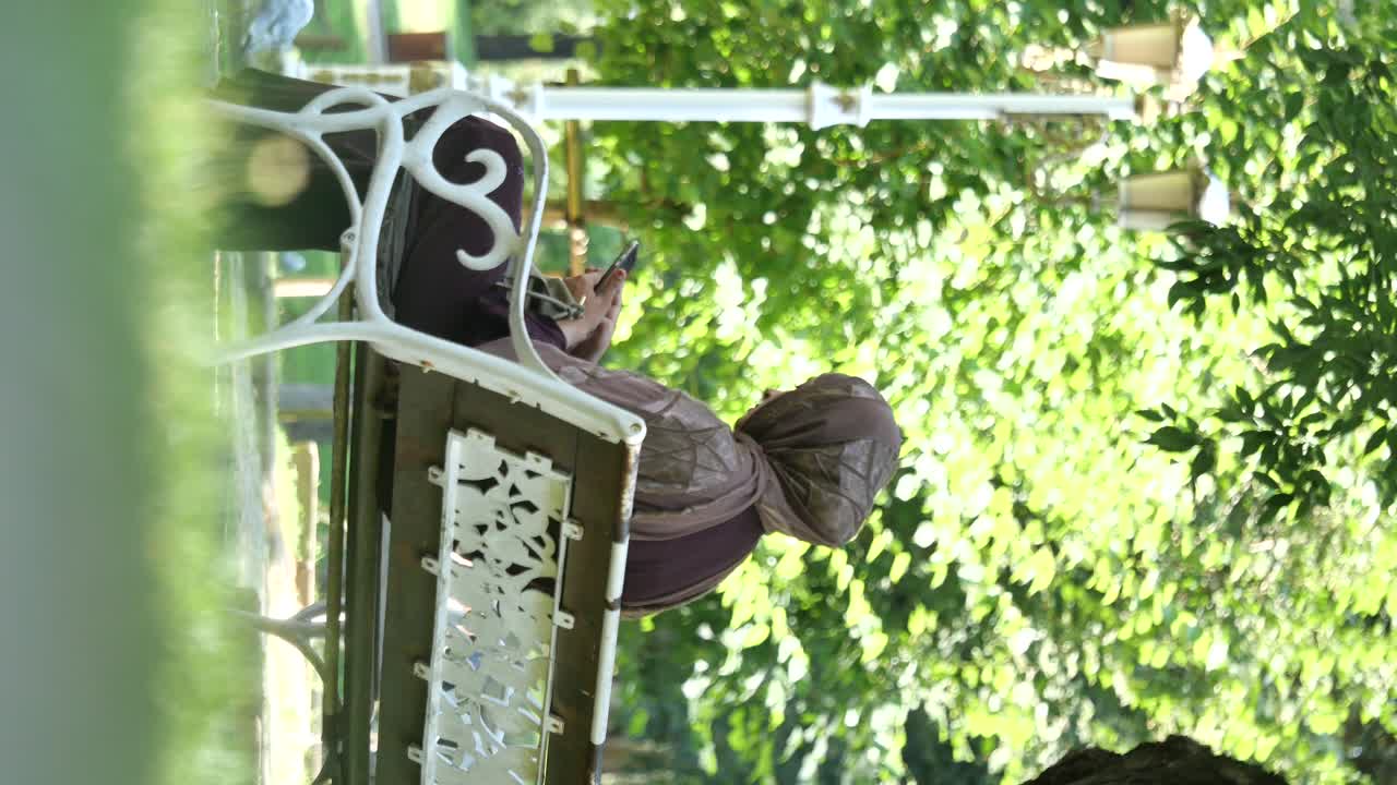 Woman Relaxing on a Bench in a Park