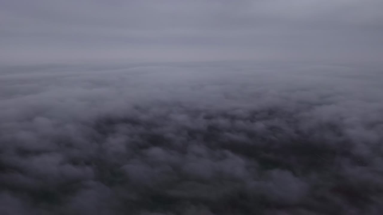 Dark moody aerial view above thick cloud cover creating ominous atmosphere and dramatic sky