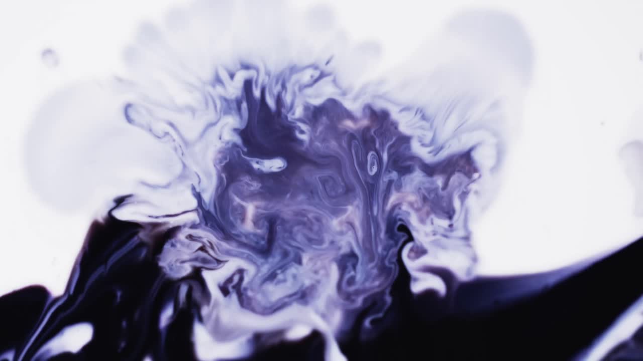Slow motion video of purple watercolor ink mixing in water against grey background