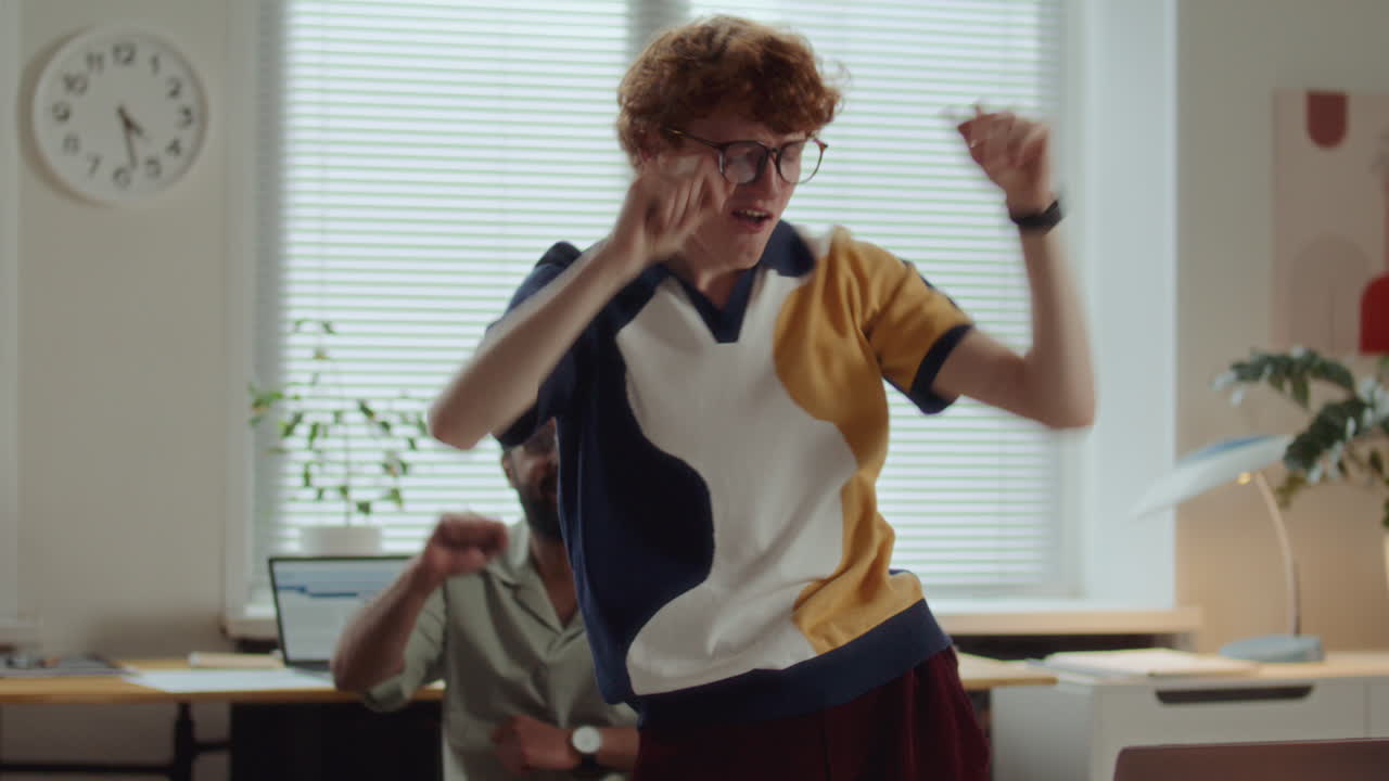 Young Office Worker Using Laptop, Then Dancing and Celebrating Success