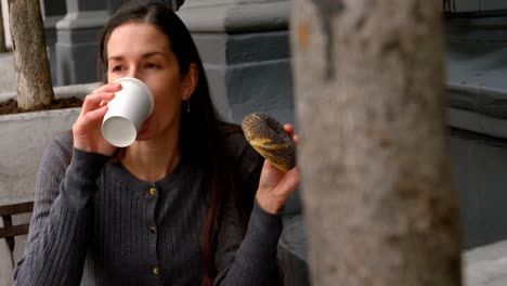 Bella-Mujer-Usando-Teléfono-Móvil-Mientras-Toma-Café-En-Una-Cafetería-Al-Aire-Libre-4k