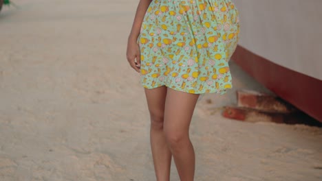 close up of legs and waist of a girl in a sundress fluttering in the wind, slowmotion