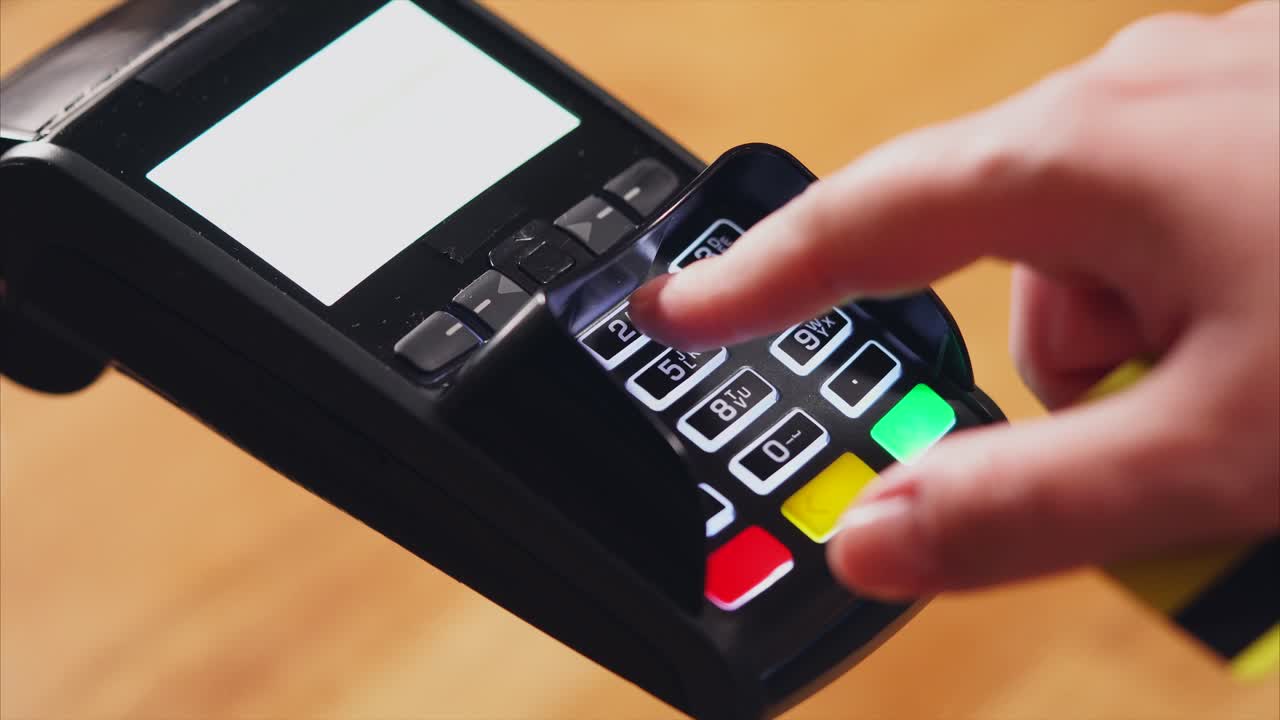 persona que utiliza un terminal de pago para procesar una transacción con tarjeta de crédito