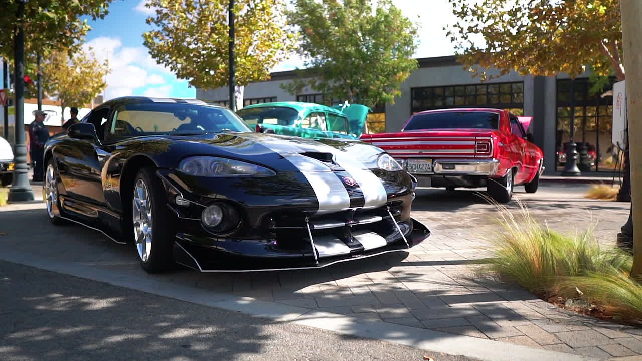 Sleek black Dodge Viper GTS sports car on car show display, tracking