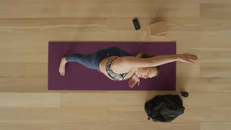 overhead view flexible yoga woman practicing reverse warrior pose enjoying healthy lifestyle exercising in fitness studio training on exercise mat