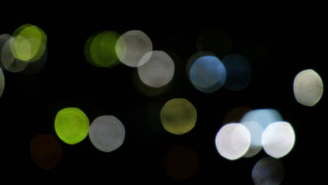 bokeh video background of light circles on black. lense light leaks effect