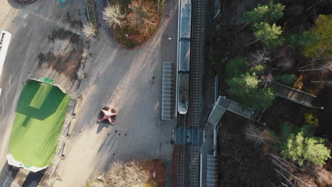 aerial top down shot of people commuting at bergsjön rymdtorget tram stop in gothenburg, sweden