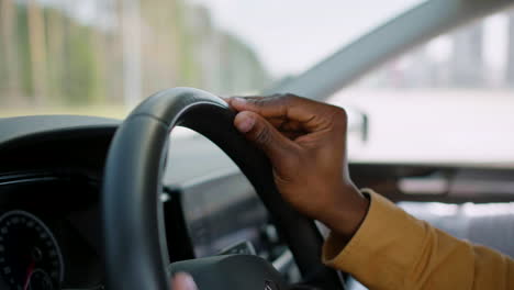 Man-holding-steering-wheel