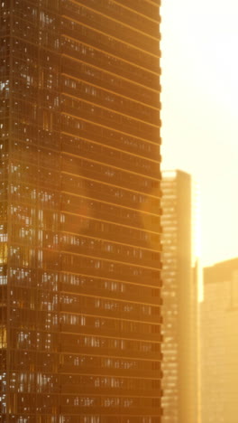 a skyscraper reflecting the golden hour sun in the city