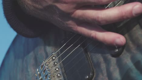 closeup of someone playing an electric guitar