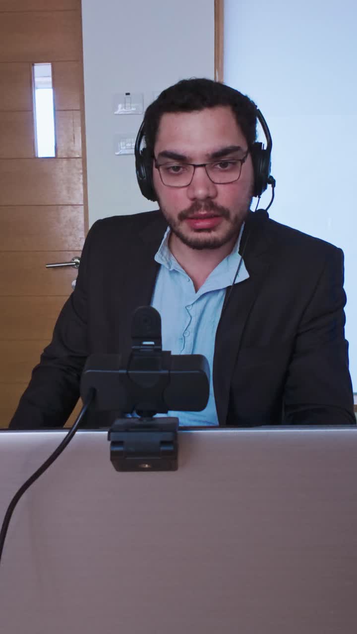 Man Presenting and Talking in a Business Webinar from His Desk
