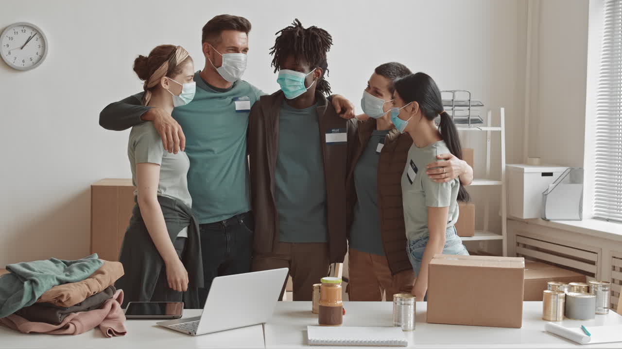 Volunteers wearing face masks packing donations