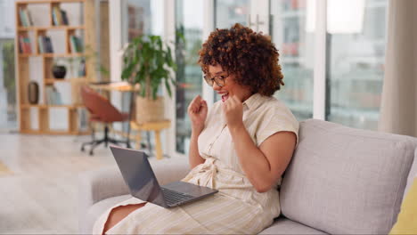 Laptop,-winner-and-celebration-of-woman-on-sofa