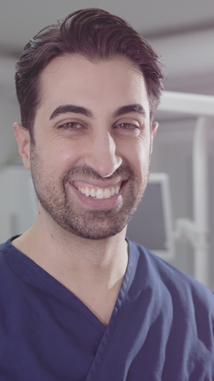 Smiling healthcare professional looking at camera in medical office, vertical