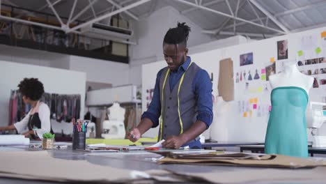 Mixed race man working in fashion office