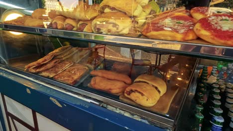 assorted pastries and breads in a bakery display