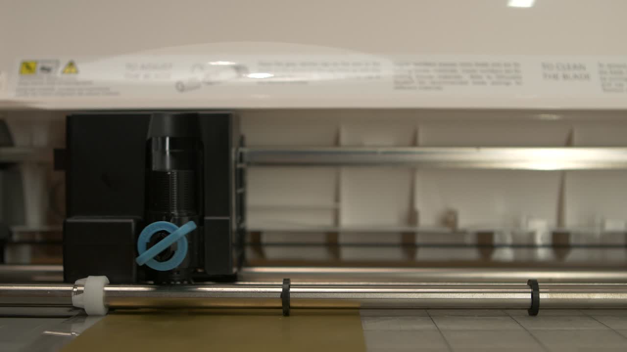 A desktop cutter is cutting foil