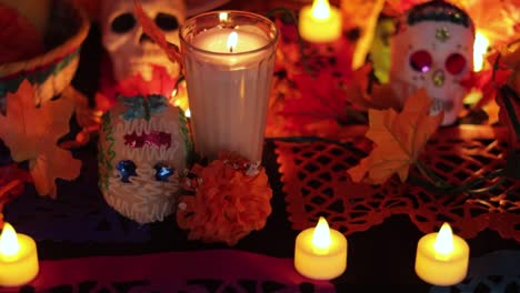 Led-candles,-papel-picado,-sugar-skulls-and-others-Day-of-the-dead-stuffs,-tilt-up