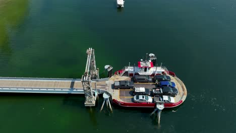 Overhead-aerial-view-of-a-truck-driving-onto-a-small-private-ferry-in-the-Puget-Sound