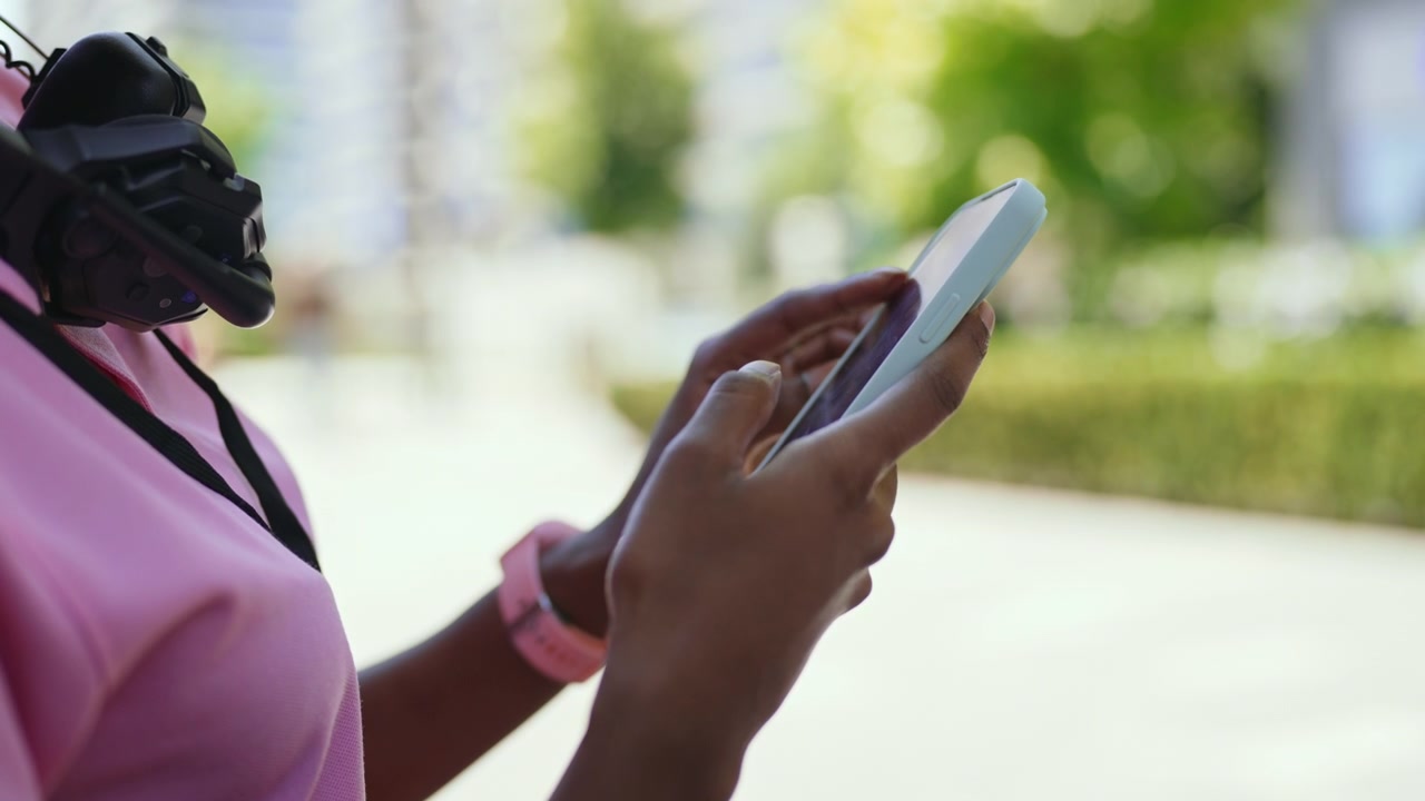 Young Woman Using Smartphone Outdoors in Urban Setting