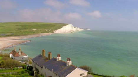 areal shot of beautiful houses along the shore of the white cliffs of dover at beachy head england