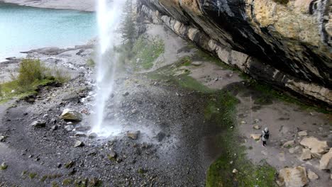 Aerial-take-of-a-spectacular-waterfall-in-The-Oeschinen-blue-lake-in-Switzerland