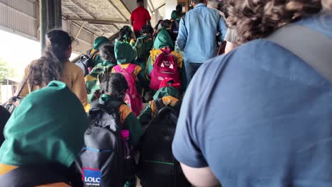 school children on a field trip at a train station