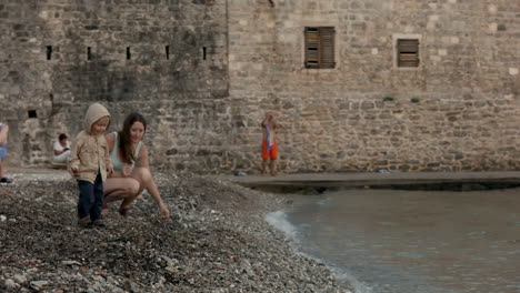 mother and child playing on the beach