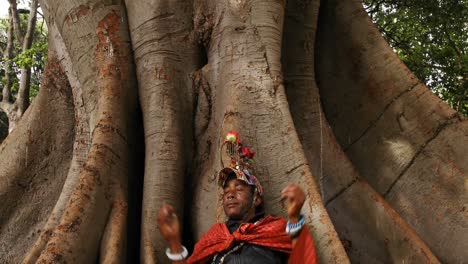 tribal man relaxing under a tree 4k