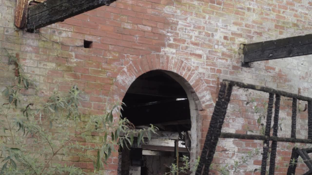 Derelict abandoned brick building archway after fire