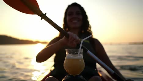 a serene sunset kayaking experience with a refreshing beverage, capturing the joy of outdoor adventure and relaxation by the water.