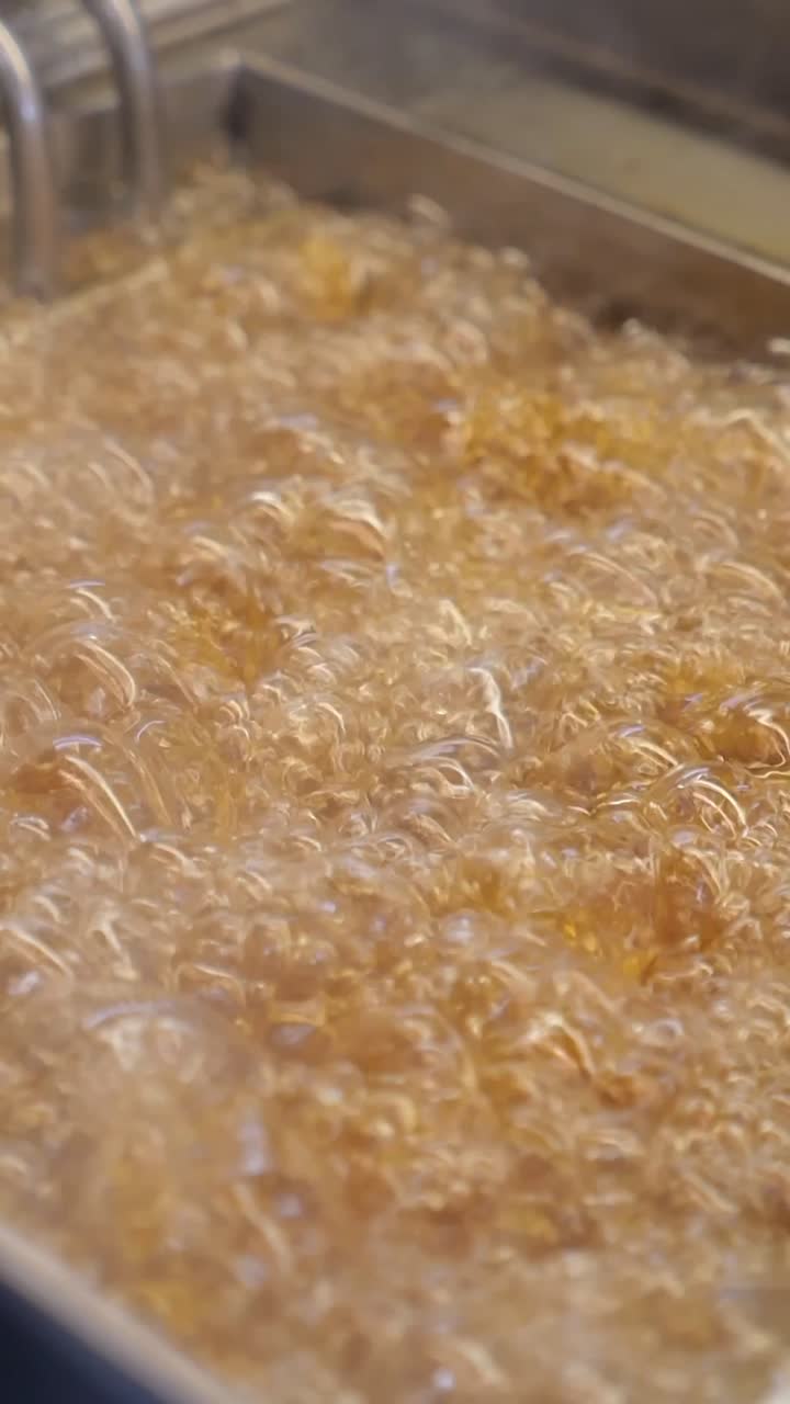 Golden Hot Oil Bubbling in a Commercial Deep Fryer