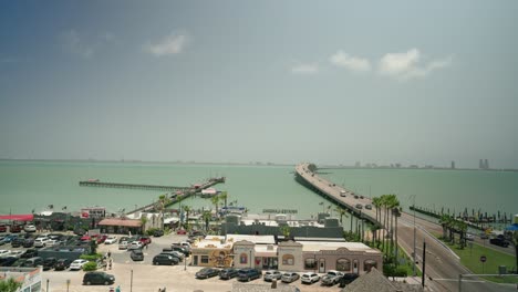 View-from-Port-Isabel-Texas-overlooking-overwater-highway-road-to-South-Padre-island-with-tourists-driving-cars-to-summer-vacation