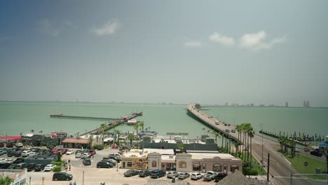 view from port isabel texas overlooking overwater highway road to south padre island with tourists driving cars to summer vacation