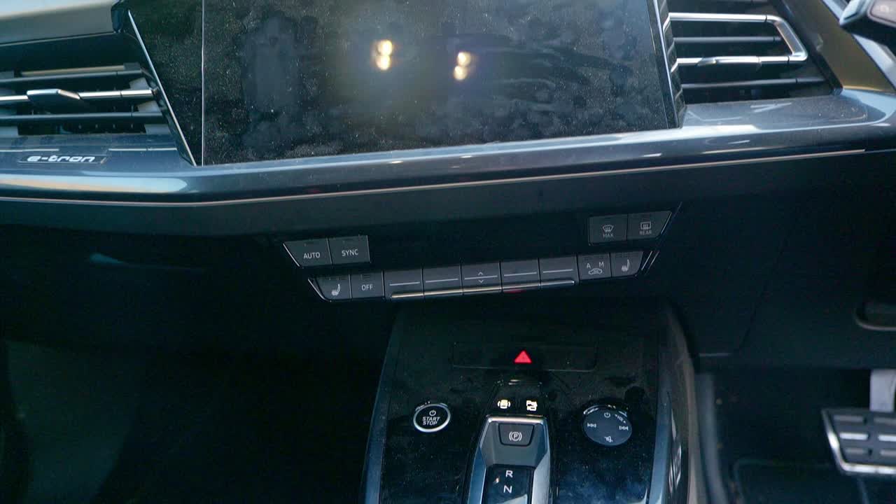 Very dirty centre console, cupholders and infotainment screen - medium shot - tilting up