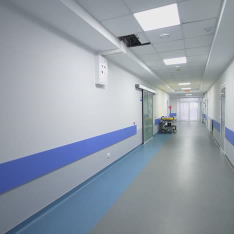 long corridor with doors. long empty light corridor in hospital