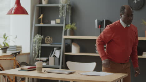 black businessman leaving office in end of workday