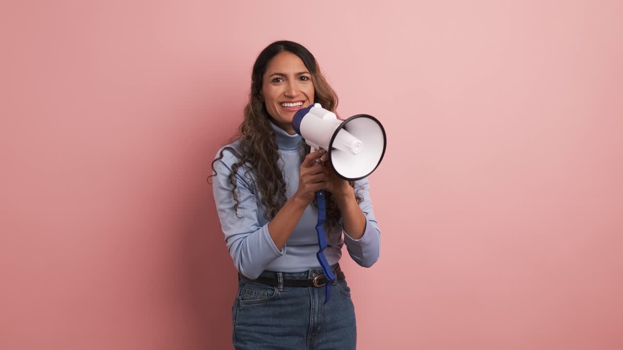 Colombian woman using a loudspeaker and yelling positive