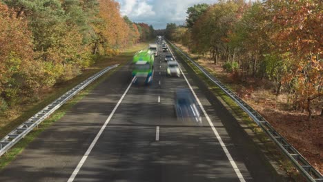 land transport speeding at a28 highway in netherlands with autumn foliage on a sunny day